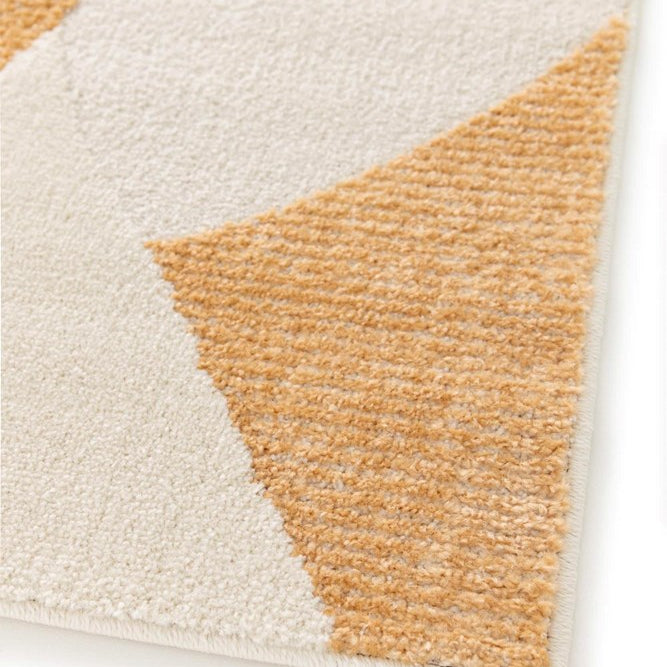 Close-up of a geometric-patterned rug with brown and beige triangles on a white background