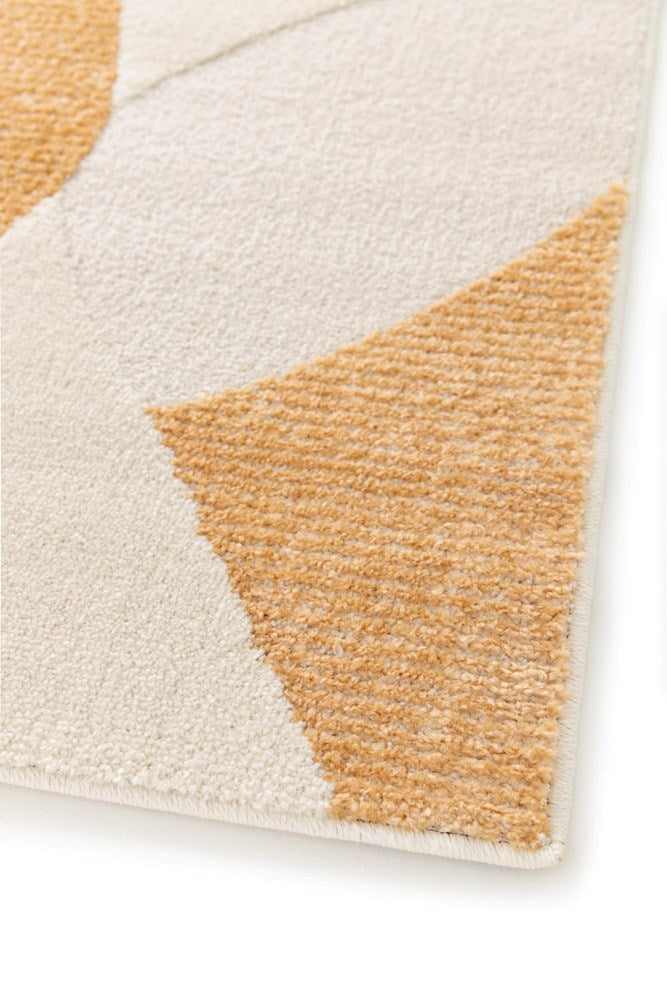 Close-up of a geometric-patterned rug with brown and beige triangles on a white background