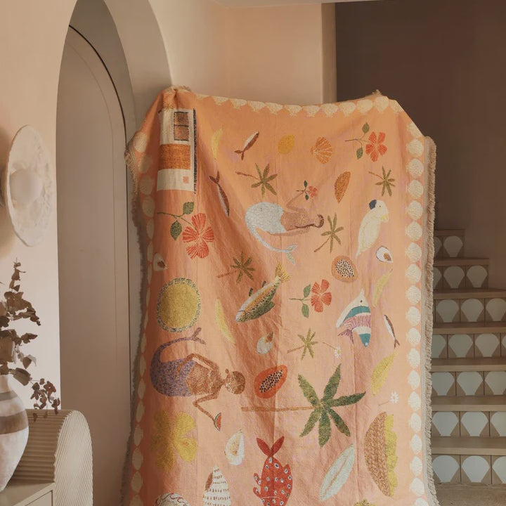 Colorful children's rug with animal patterns on a tiled floor.
