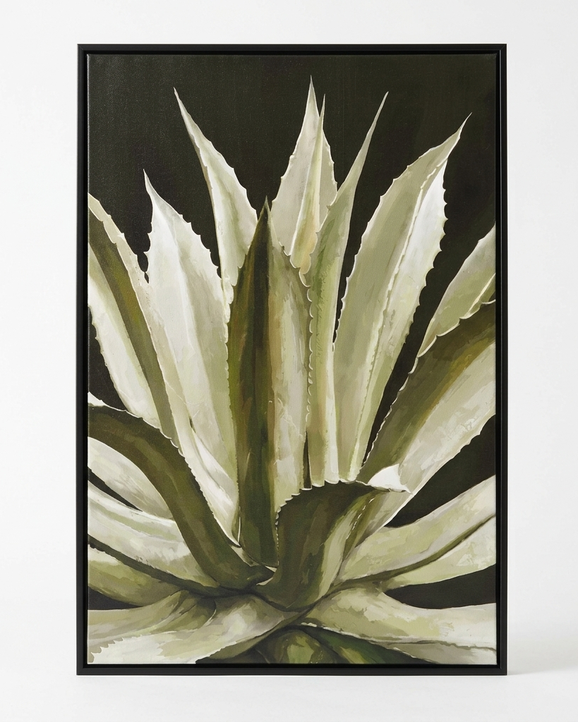 A framed botanical art print of an agave plant, featuring textured cream and olive green leaves against a dark background, enclosed in a thin black frame.