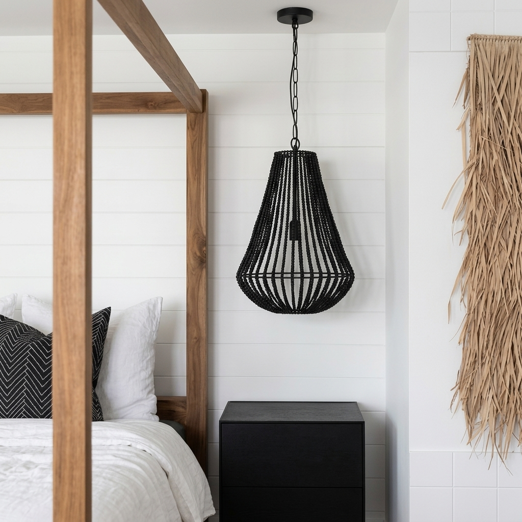 A black woven pendant light hanging in a bedroom next to a wooden bed frame and white shiplap wall.