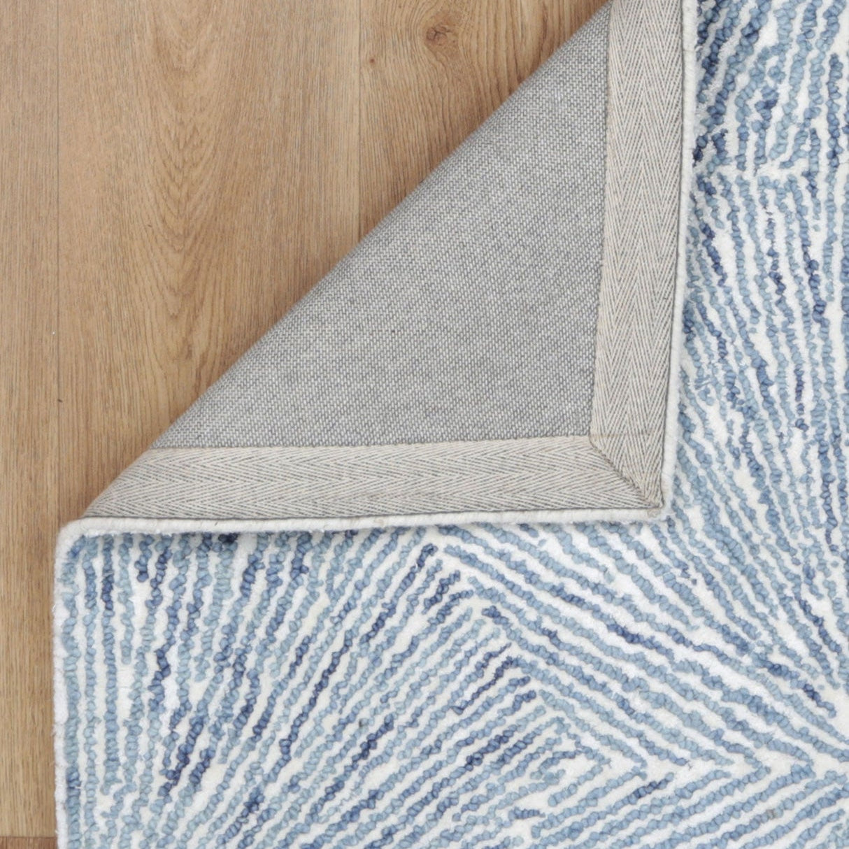 Astrid Hexagon Blue Rug backing on timber flooring