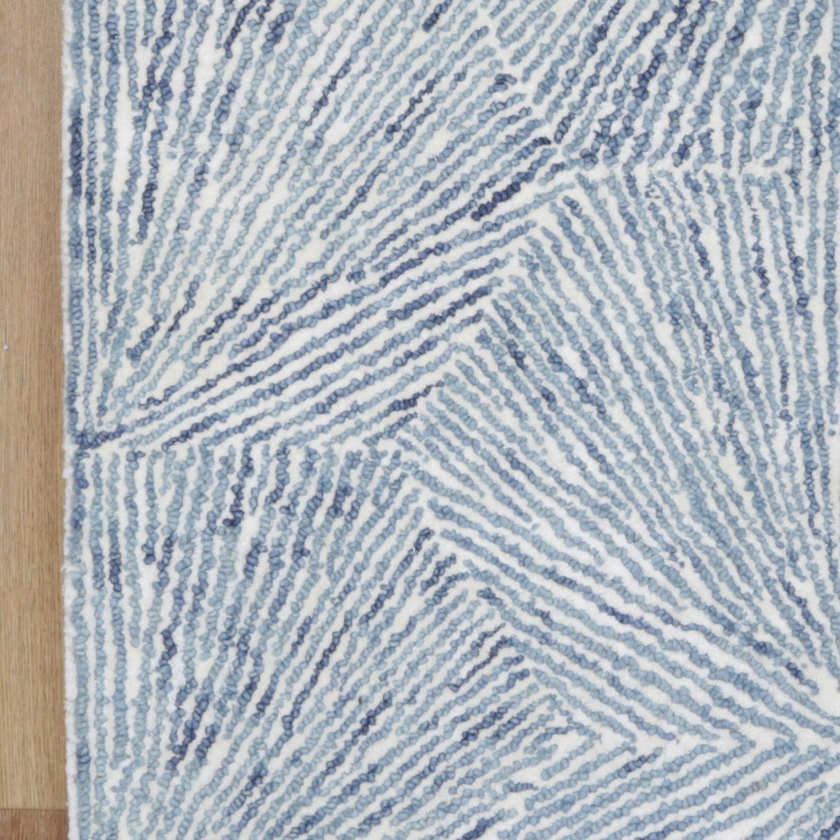 Astrid Hexagon Blue Rug on timber flooring