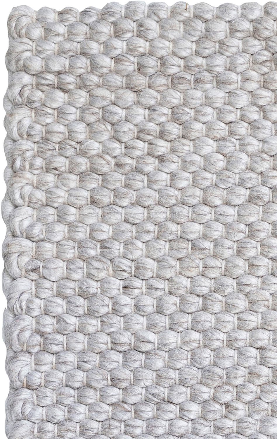 Close-up of a textured woven rug with a geometric pattern.