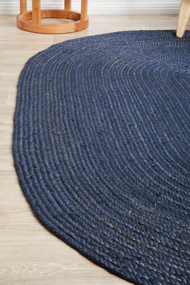 Round blue braided rug on a wooden floor