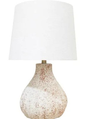 A table lamp with a textured, speckled beige and white ceramic base and a large white fabric drum shade, shown against a plain white background.