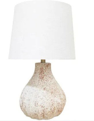 A table lamp with a textured, speckled beige and white ceramic base and a large white fabric drum shade, shown against a plain white background.