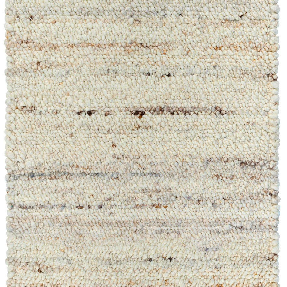 Textured area rug with a neutral color palette on a white background