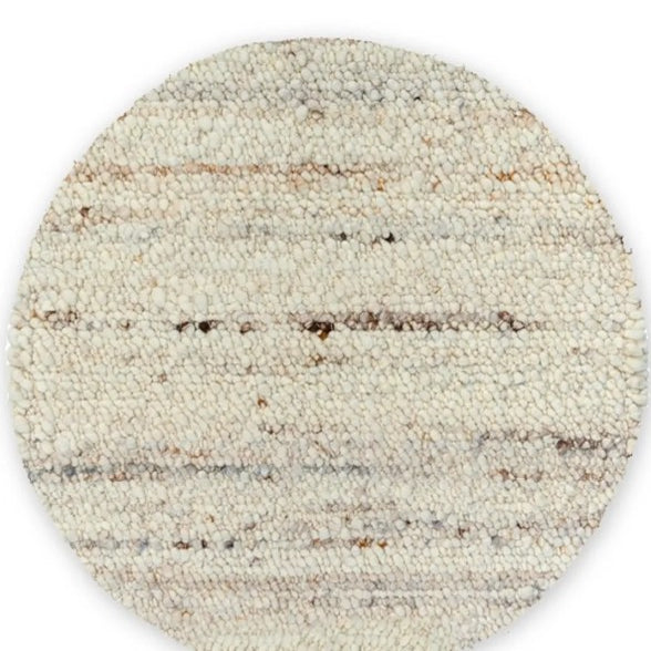 A round Belgium wool rug with a textured looped and sheared design in mushroom color.