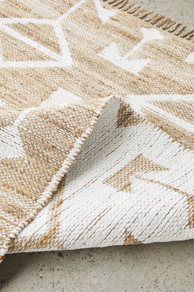 The Bodhi - Trudy Rug rolled up, showcasing its flexibility and ease of handling, highlighting the practicality of its flat-woven design for storage and transportation.