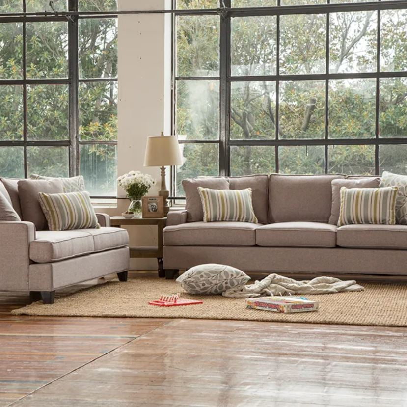 Living room with beige sofa set and large windows