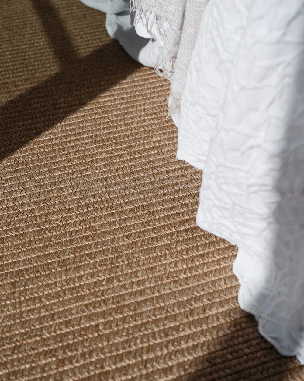 Brown textured carpet with white textured fabric on a staircase