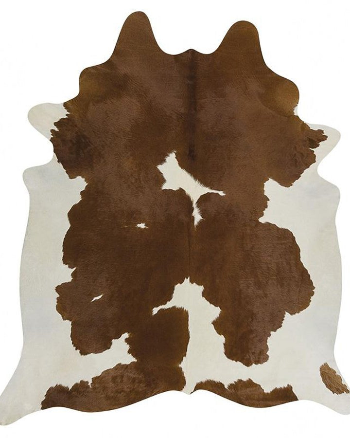Brown and white cowhide rug on a white background
