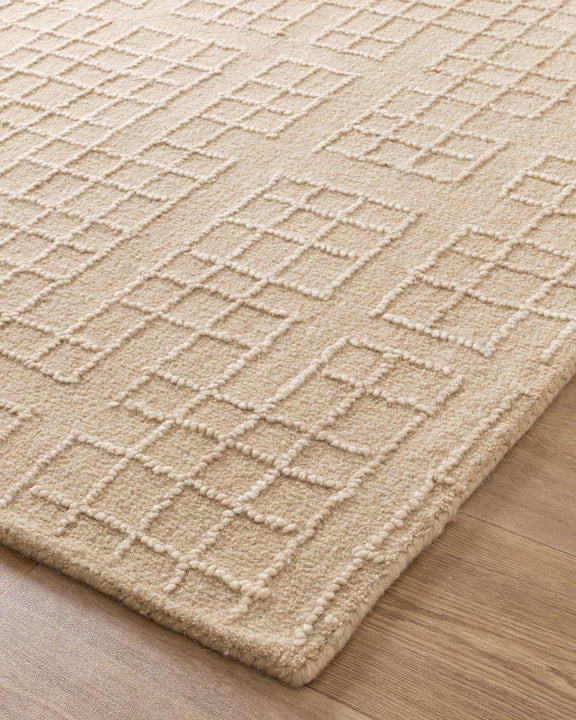 Beige textured rug on a wooden floor