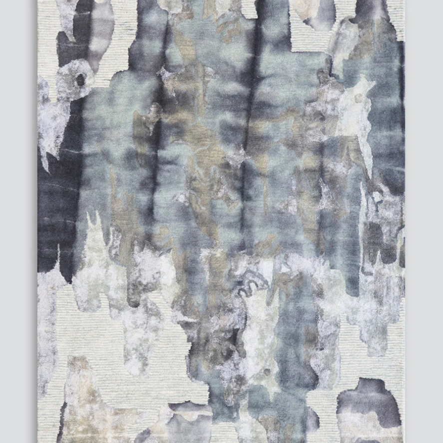 An abstract rectangular wall art piece with a textured, watercolor-like design in muted gray, slate blue, beige, and off-white tones, shown against a light gray background.