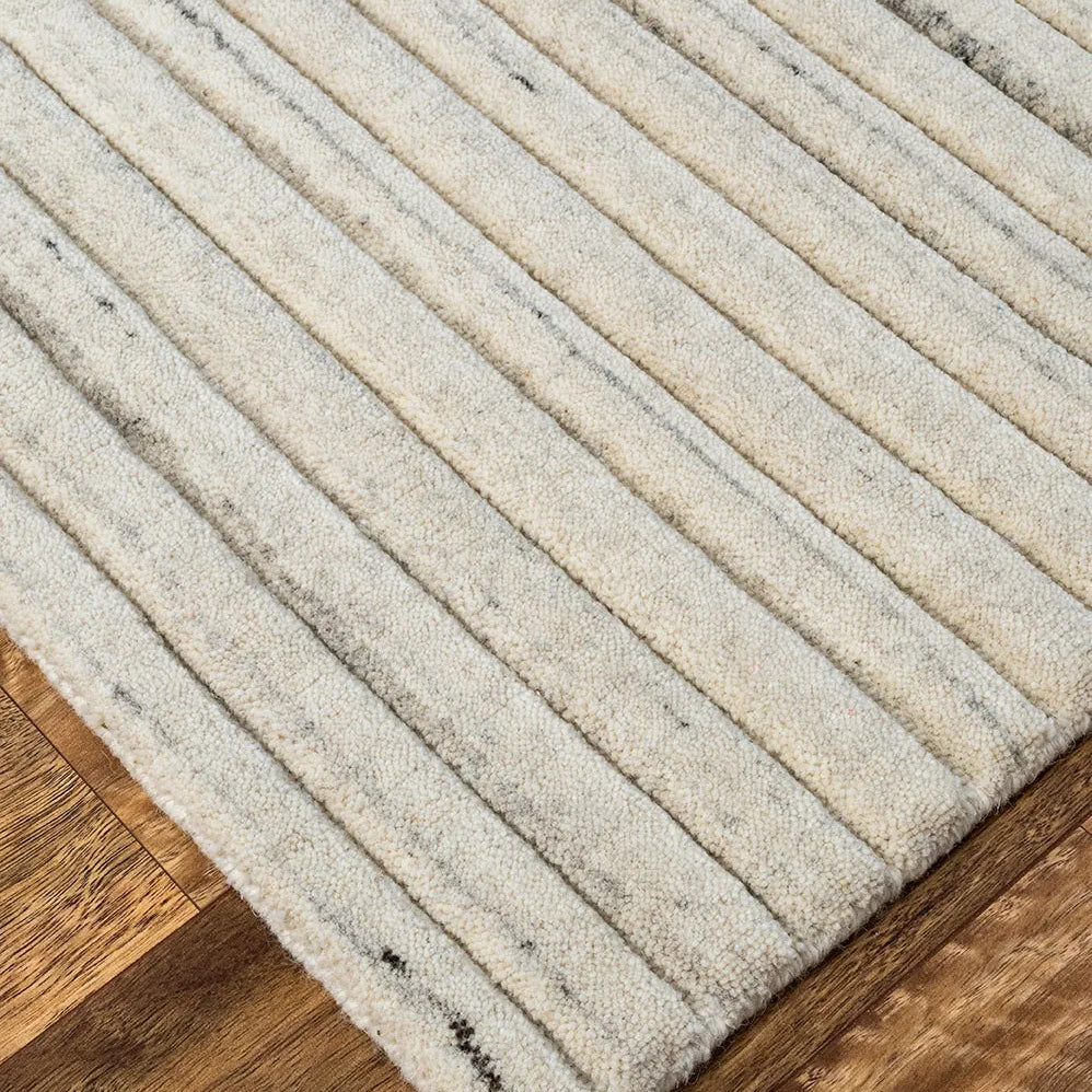 Textured rug with ribbed pattern on a wooden floor