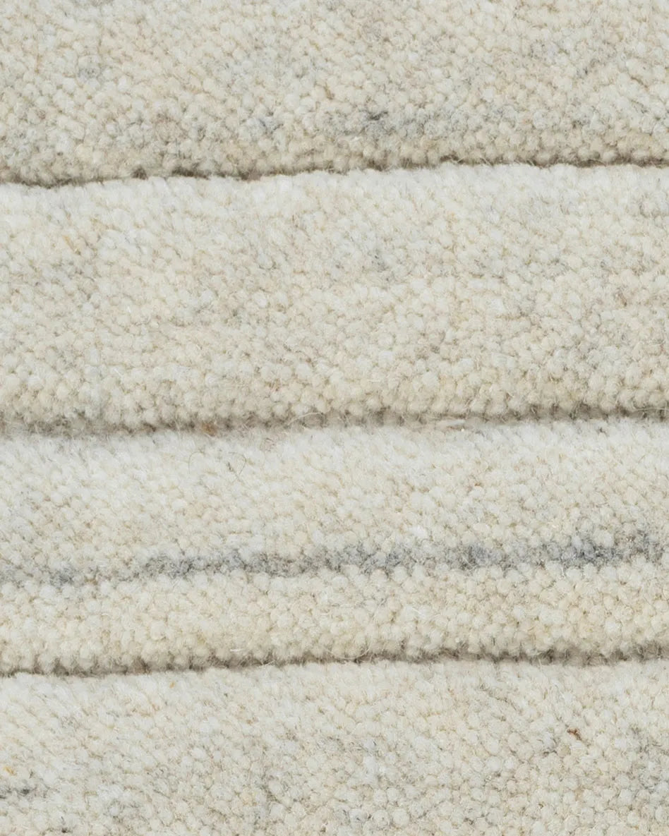 Close-up of textured beige carpet with horizontal stripes