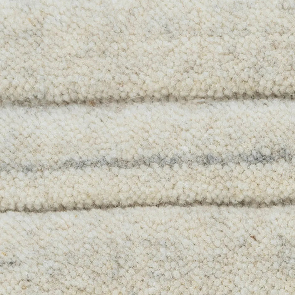 Close-up of textured beige carpet with horizontal stripes