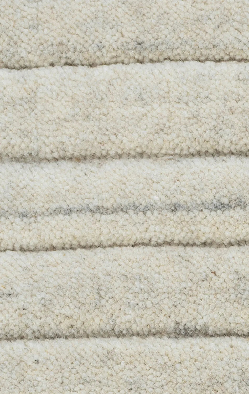 Close-up of textured beige carpet with horizontal stripes