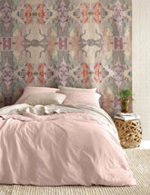 Bedroom with pink bedding and patterned wallpaper