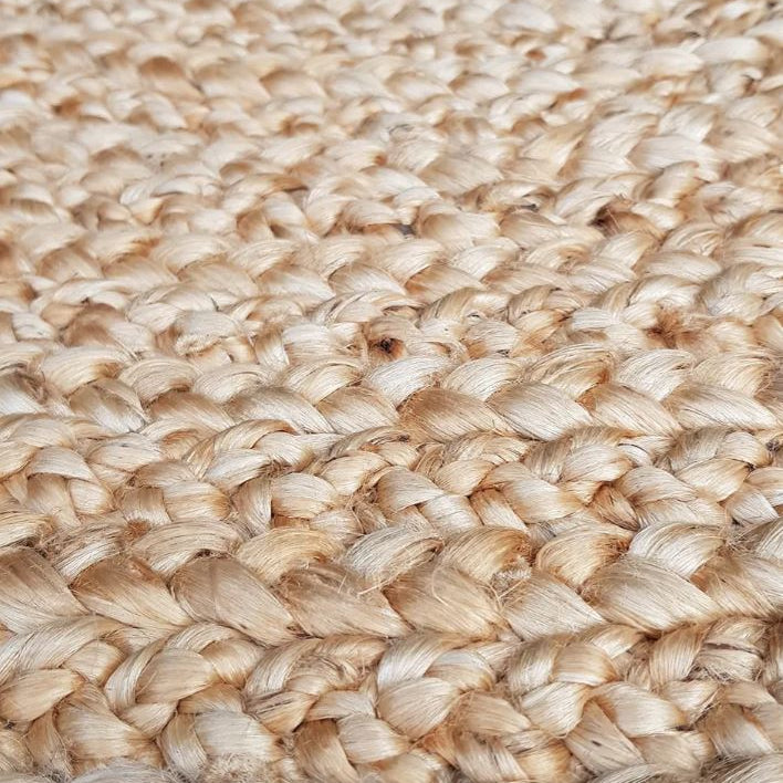Close-up of a woven jute rug with natural beige color.
