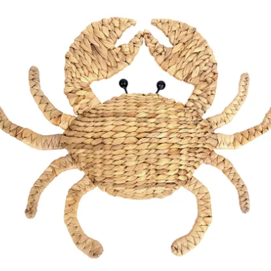 A woven straw crab wall decor piece with black bead eyes, shown against a plain white background.