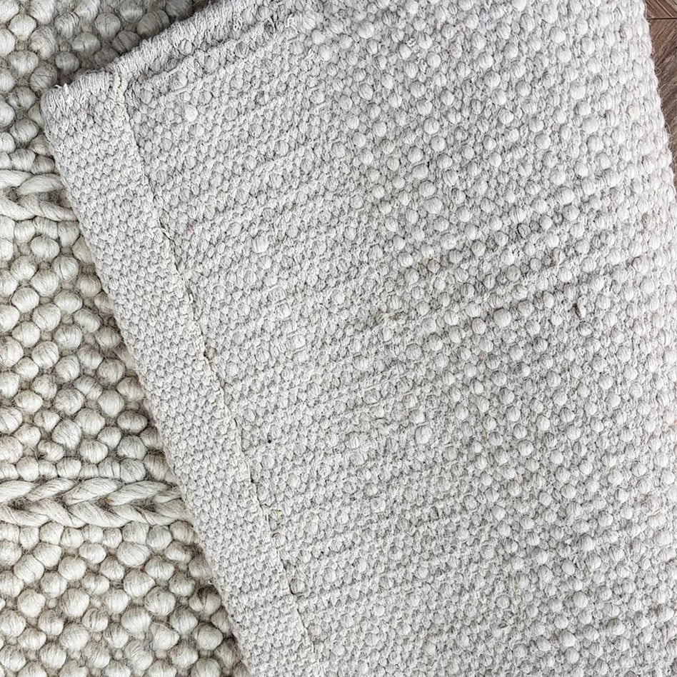 Textured gray rug on a wooden floor