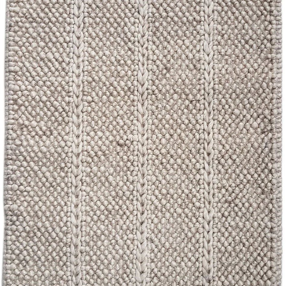 Textured beige bath mat with a woven pattern