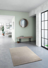 The Cumulus Rug in Stone, displayed in a living room setting, showcasing its versatility and compatibility with various home decor styles.