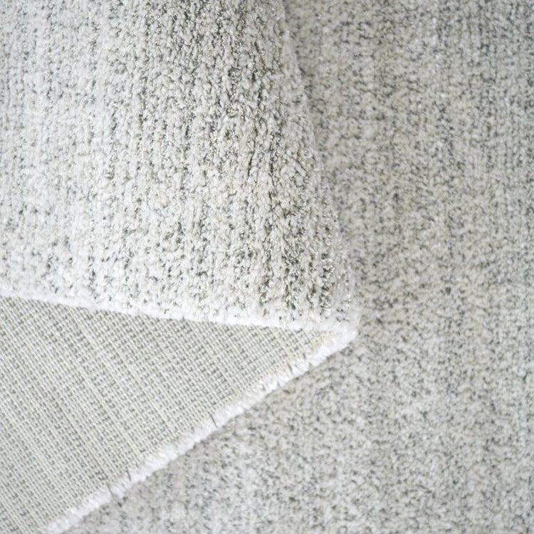 Close-up of a textured gray fabric with a subtle pattern