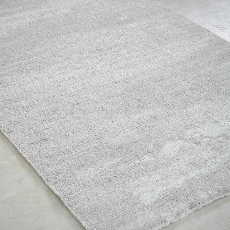 Gray textured rug on a concrete floor