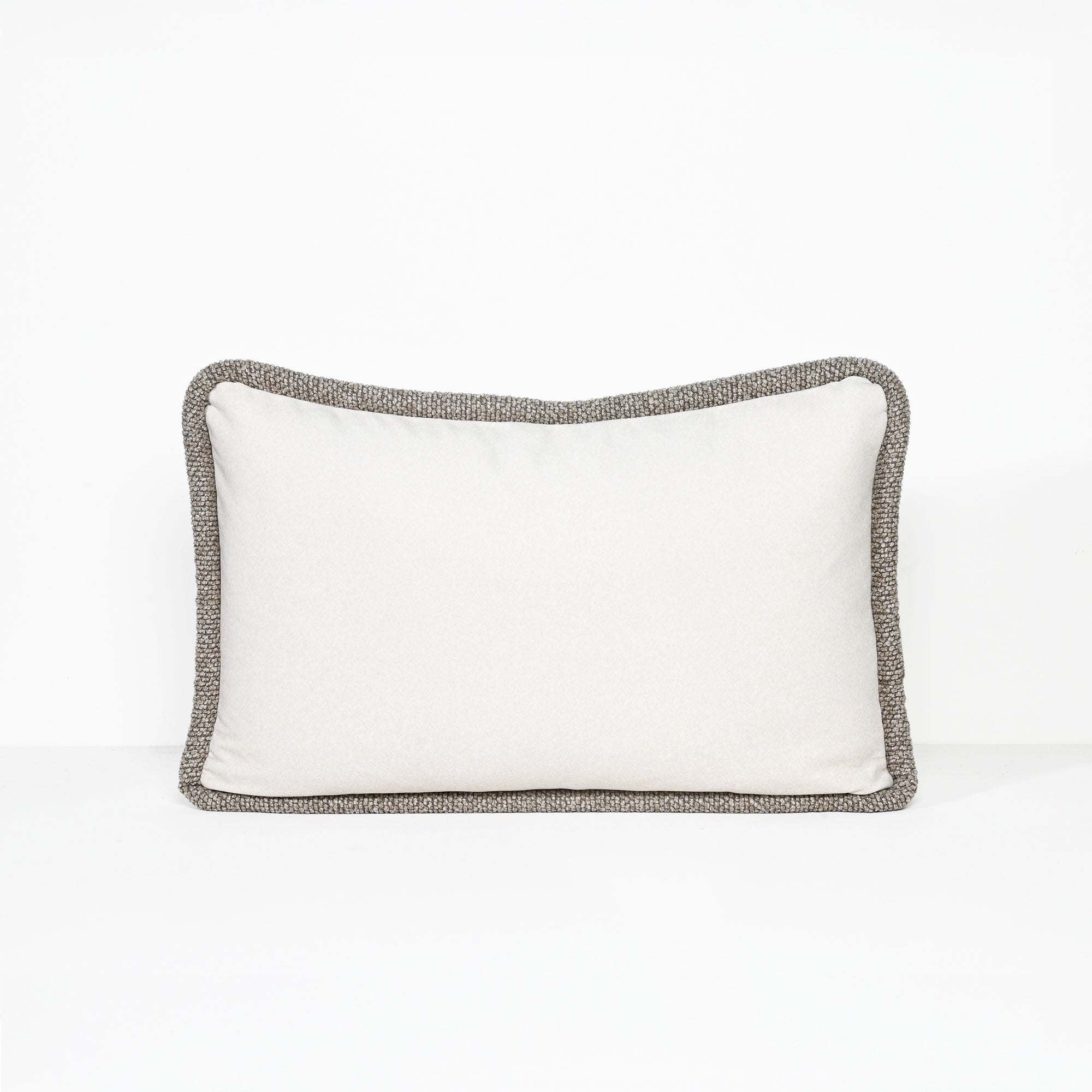 A rectangular lumbar pillow with a solid white center and a textured gray bouclé border, shown against a plain white background.