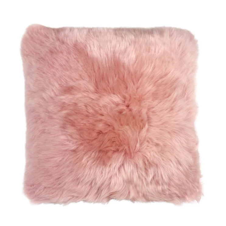 Pink fluffysheepskin pillow on a white background