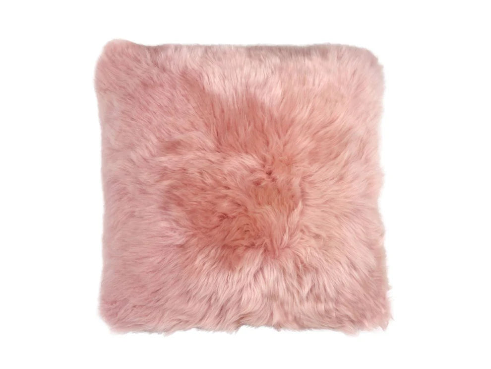 Pink fluffysheepskin pillow on a white background