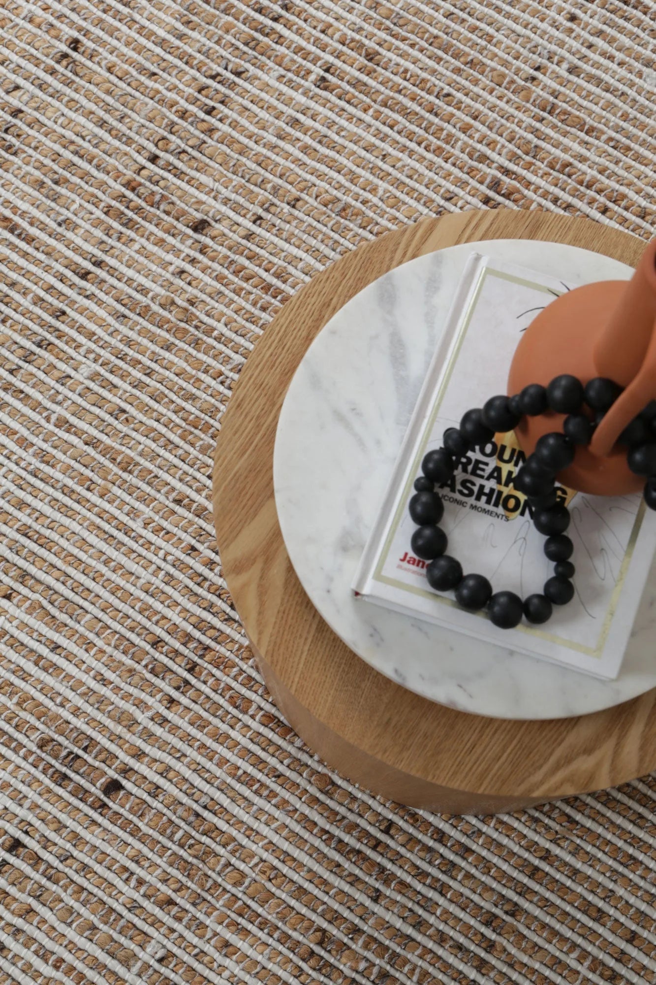 The Dune Ivory Jute & Wool Rug elegantly laid out in a lounge room, demonstrating how it complements and enhances a cozy and stylish living space.