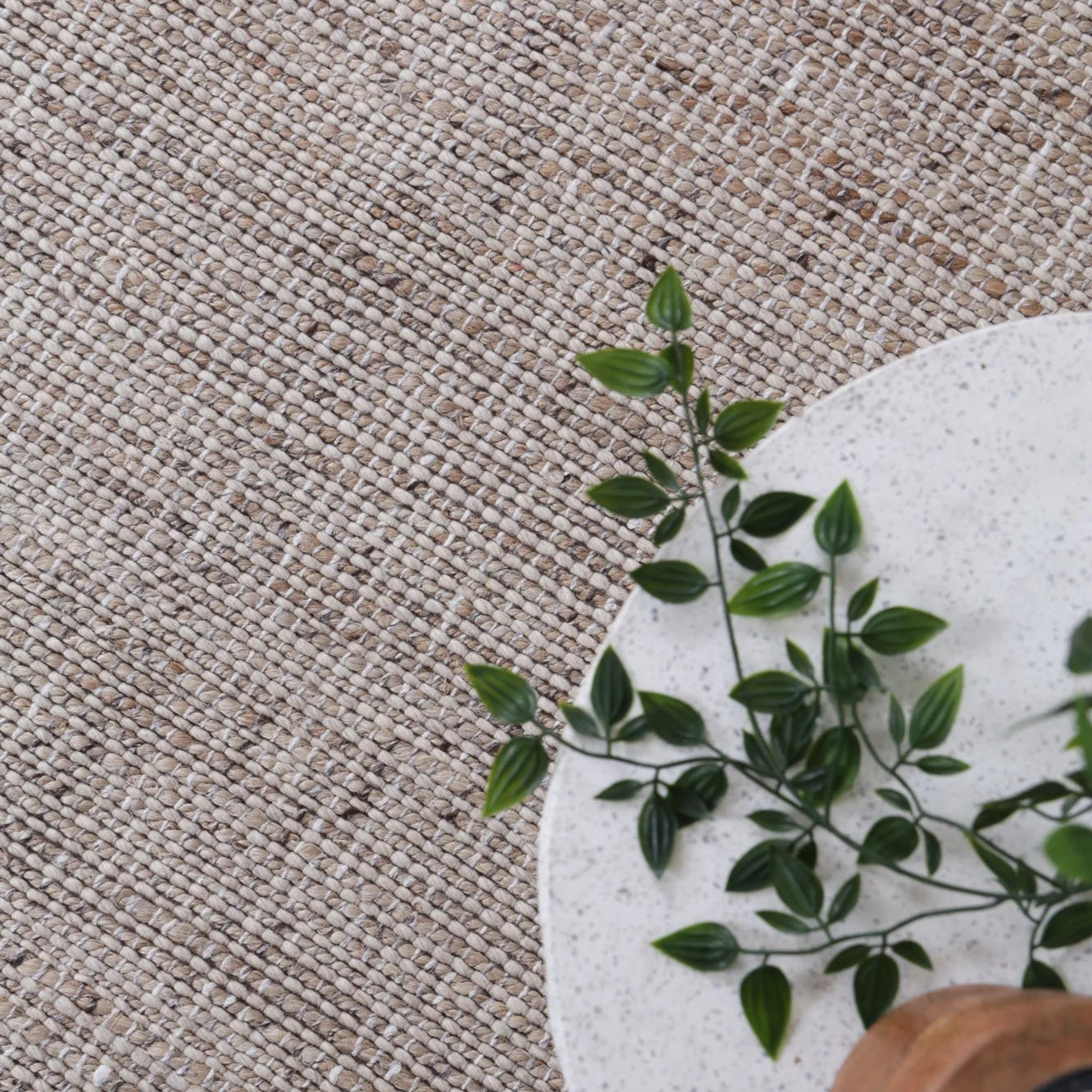 Detailed close-up of the Dune Rug's texture, highlighting the interwoven jute and wool fibers.