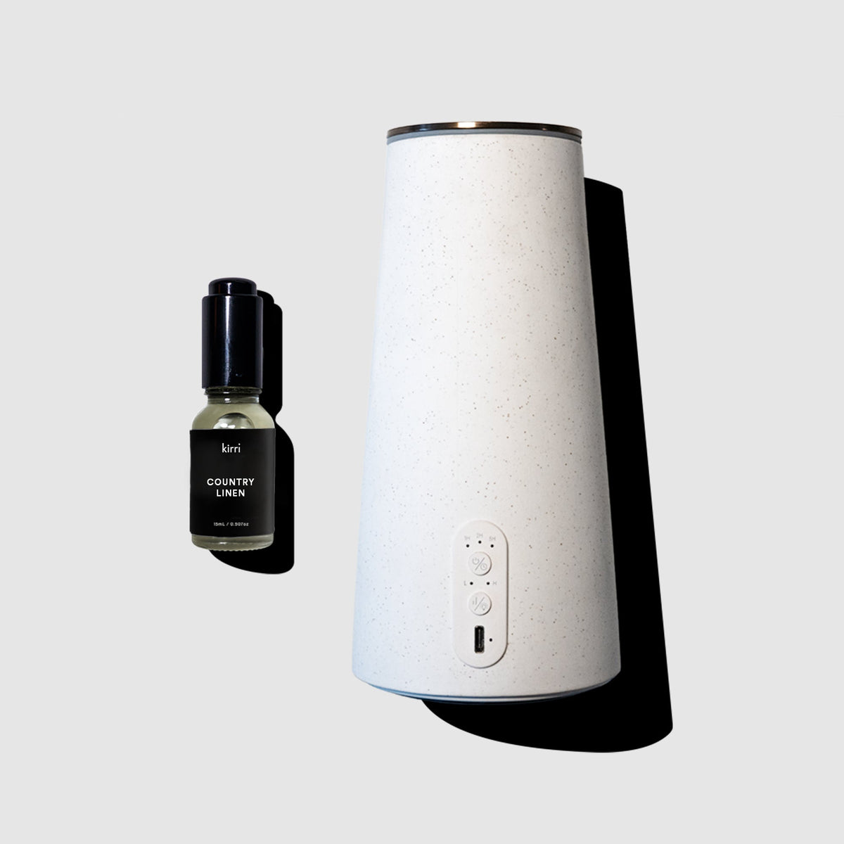 White diffuser and black bottle on a light gray background