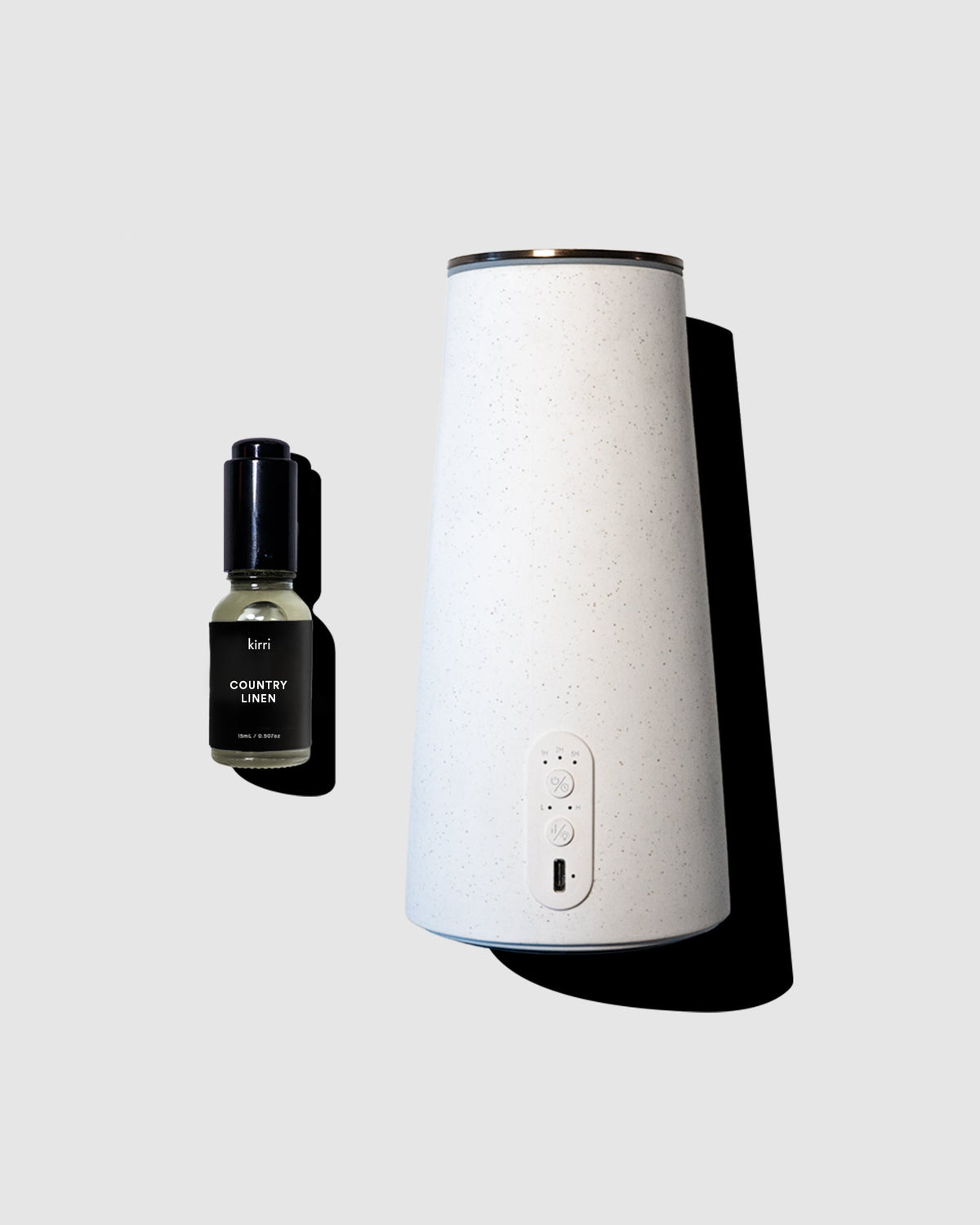 White diffuser and black bottle on a light gray background
