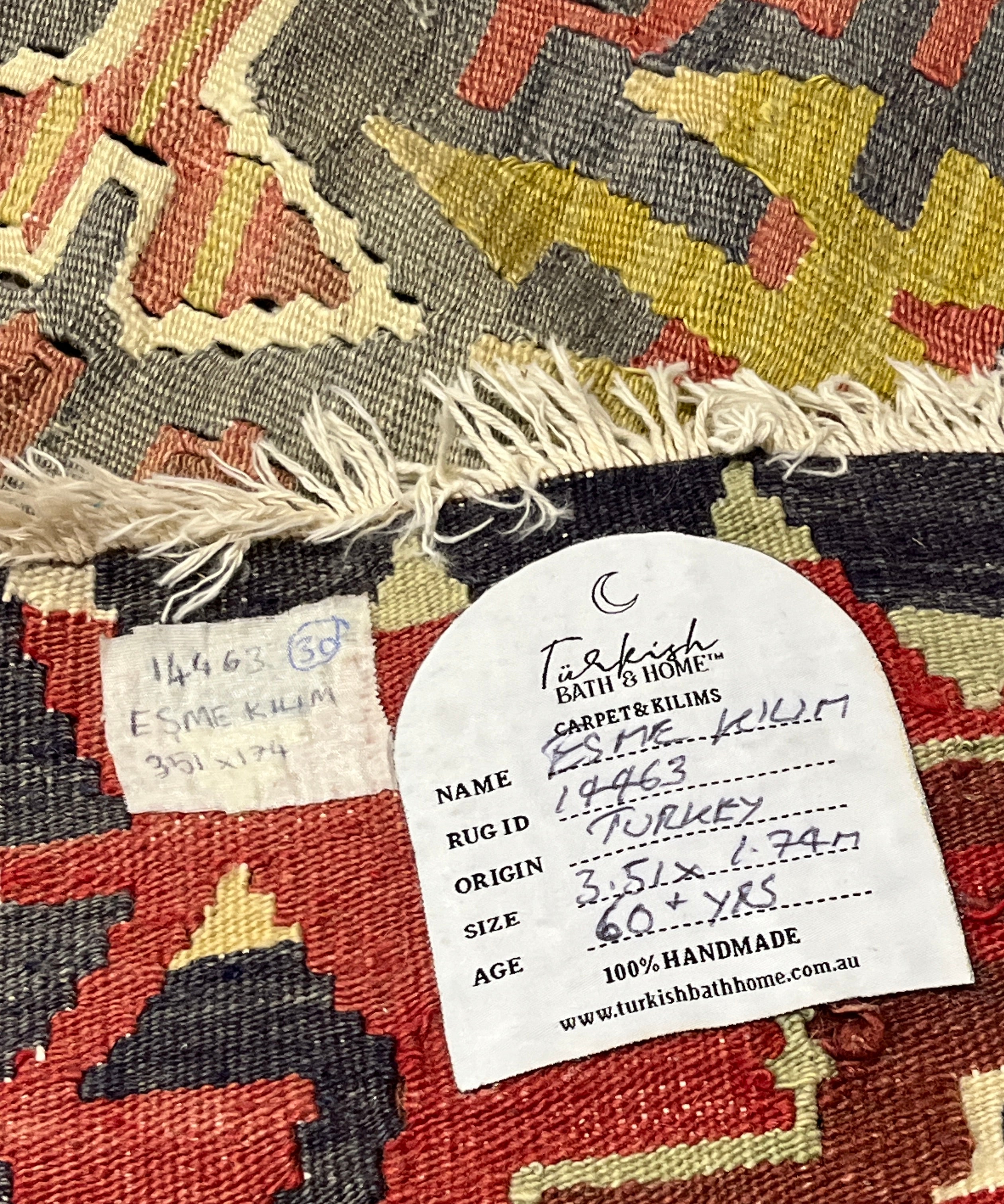 Close-up of a patterned rug with a label on it