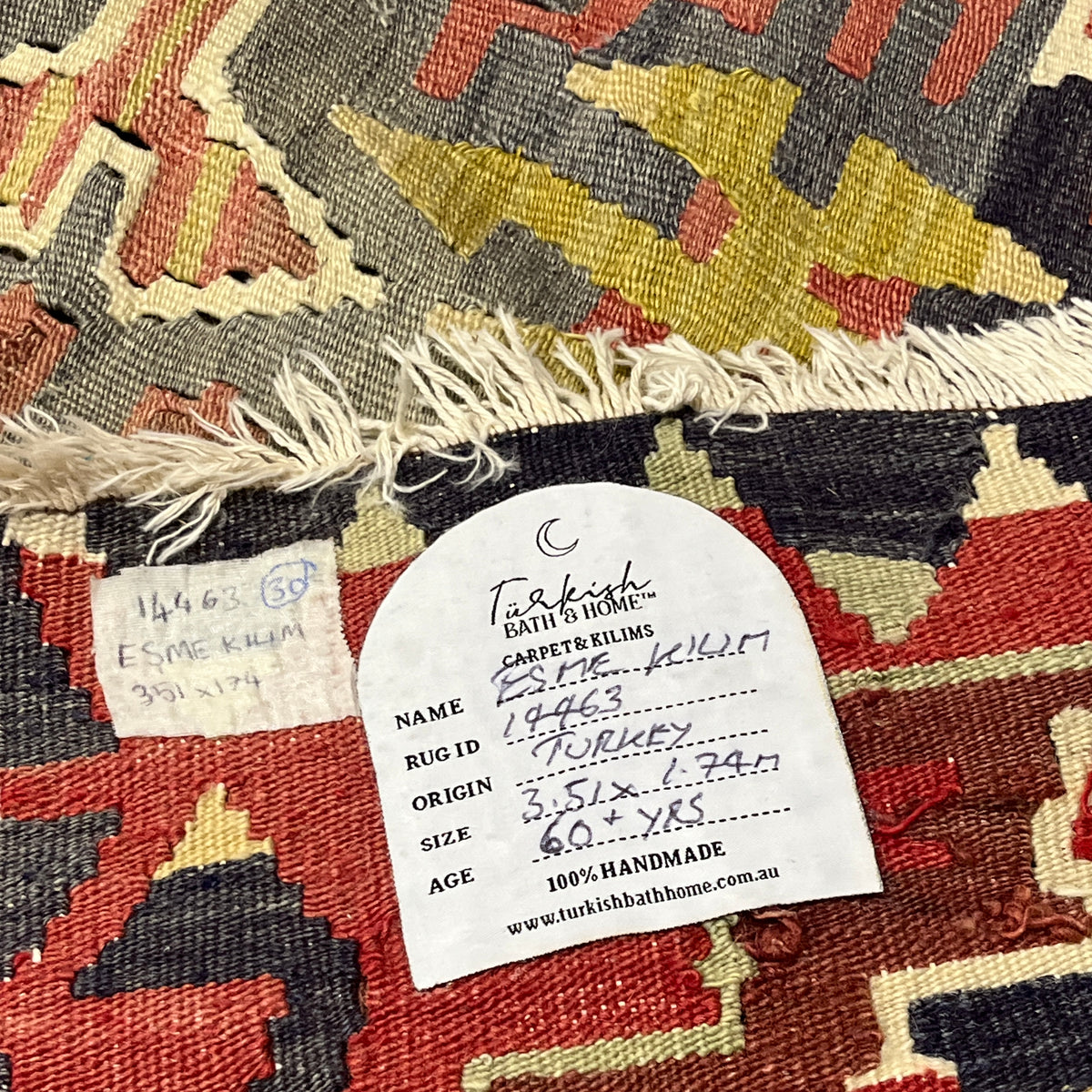 Close-up of a patterned rug with a label on it