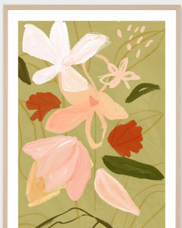 A framed botanical art print featuring stylized flowers in soft pink, peach, and rust red tones with green leaves on an olive green background, set in a light wood frame with a white mat.