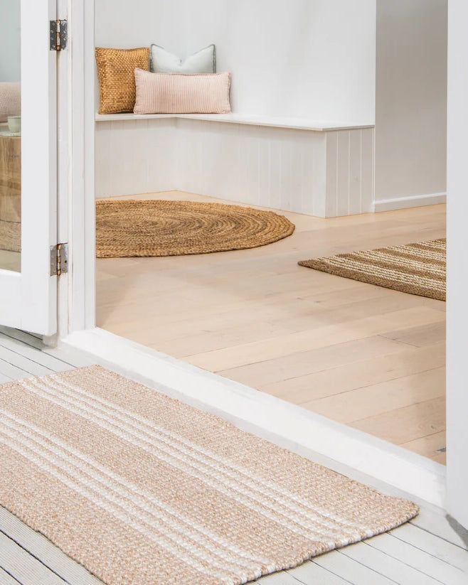 Rug on a wooden floor with a neutral color scheme