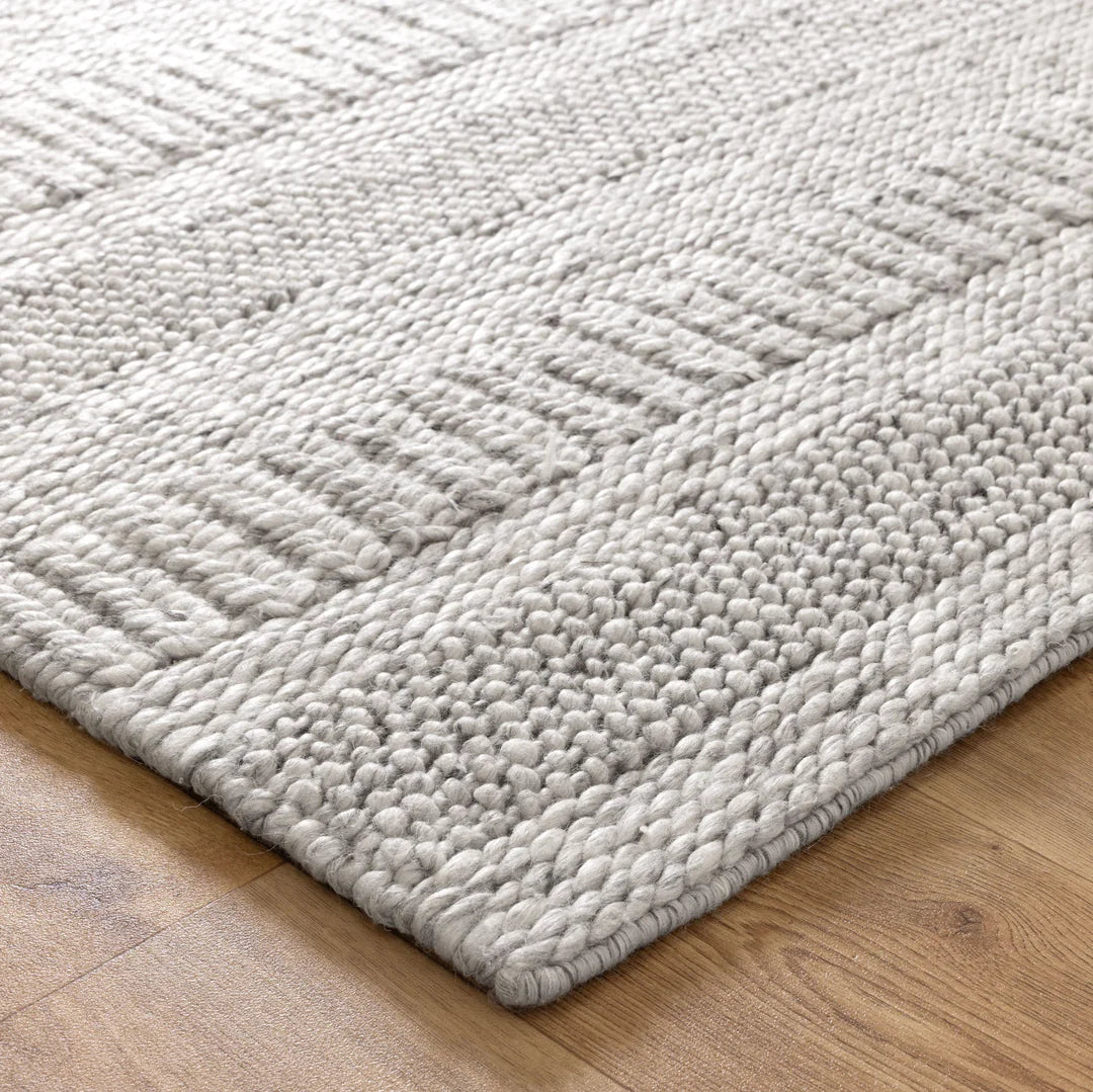 Close-up view of a grey wool and nylon area rug with a textured pattern