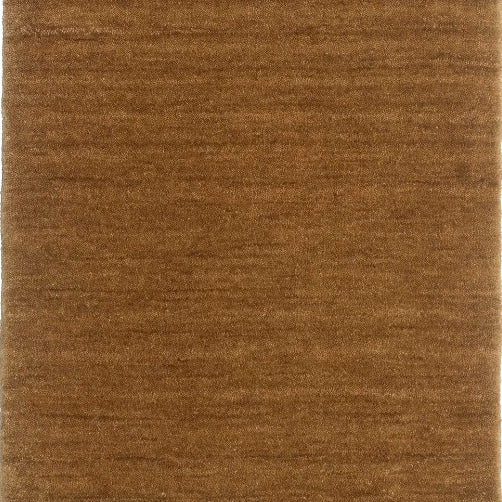 A honey brown Harlequin textured wool rug with a plush, chunky woven style.