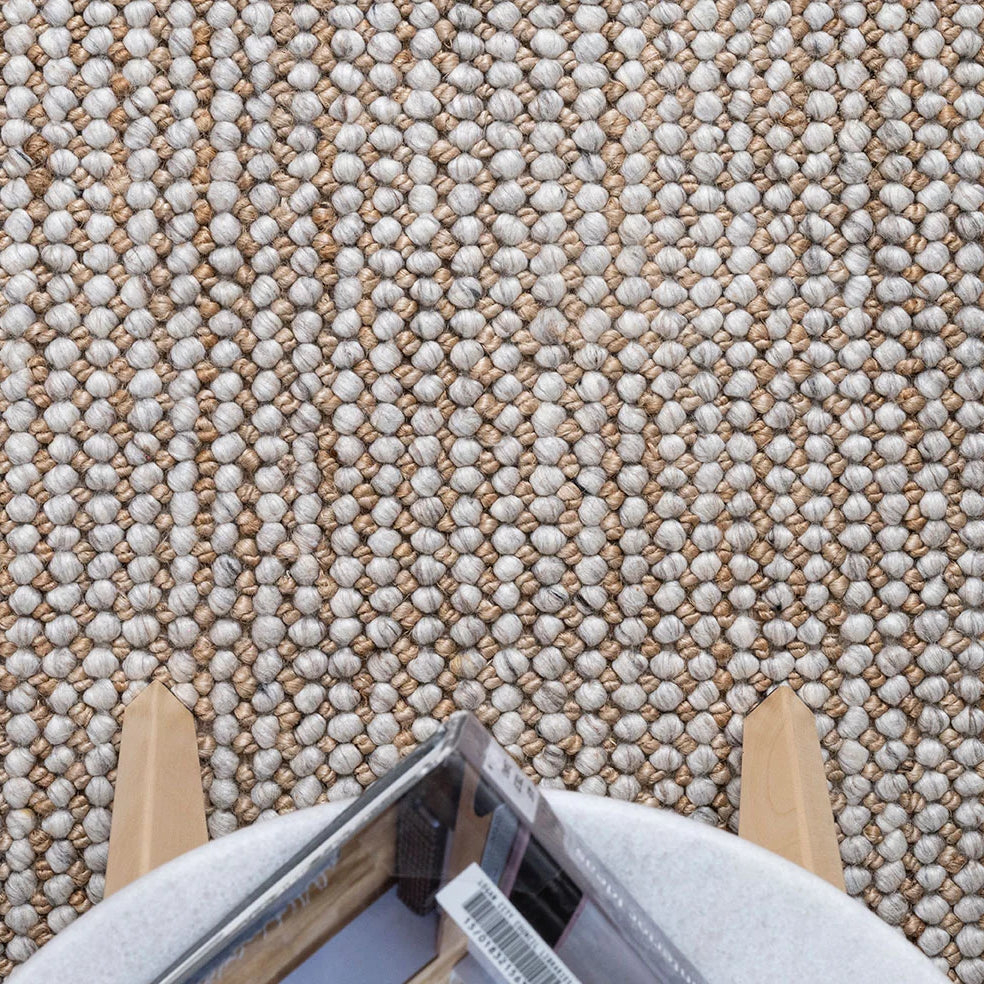 An image showing the Harmony Rug in a room setting, illustrating how its natural and silver tones complement modern interiors and add a touch of sophistication.