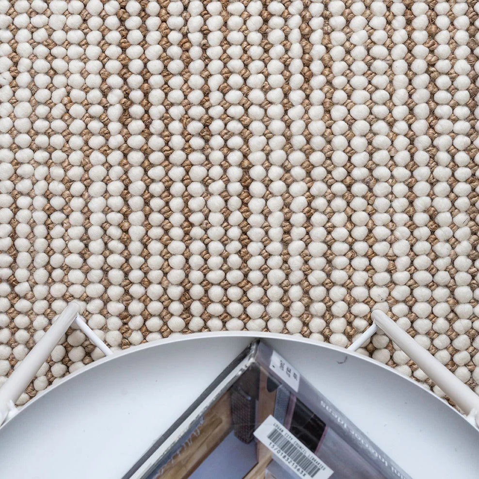 An image depicting the rug in a living space, illustrating how its earthy tones and contemporary design seamlessly integrate with various interior styles, adding warmth and character.