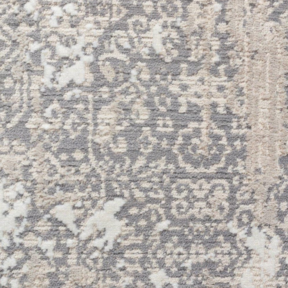 Close-up of a textured rug with a geometric pattern in neutral colors.