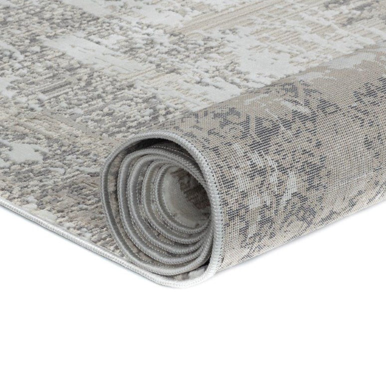 Rolled-up patterned rug on a white background