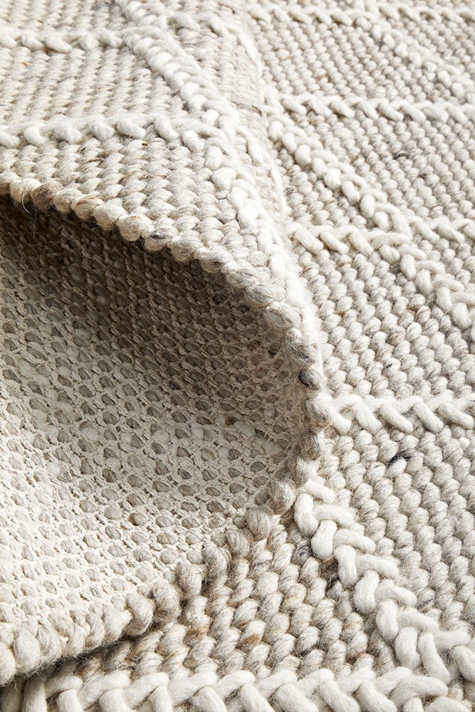 Focused image showing the fine craftsmanship of the Huxley Natural Rug, highlighting the skillful hand-loomed construction and quality materials.