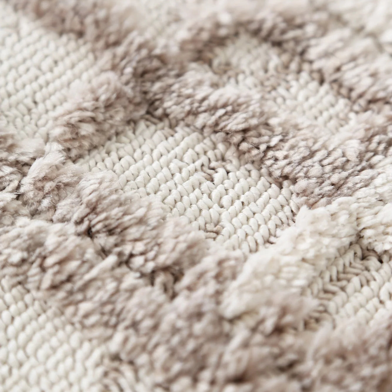 Close-up image focusing on the soft looped pile texture of the Bilbao rug.